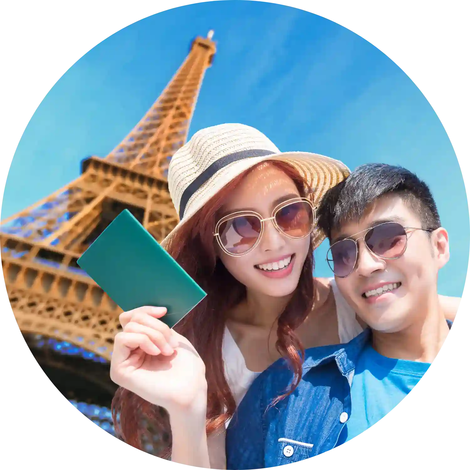 A couple posing with passports at the Eiffel Tower