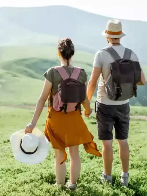 A loving couple walking hand in hand on a picturesque mountain trail.